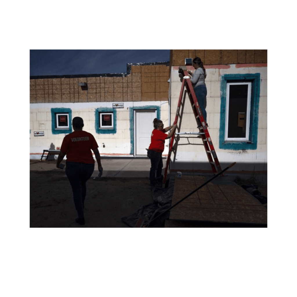 First Financial Credit Union employees Olivia Atkinson, second from right and Alyssa Case, right, work on a home with Habitat for Humanity volunteers at Albuquerque on Wednesday, Sept. 20, 2023.